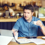 Successful new restaurant owner checking monthly reports online on tablet – middle aged man calculating bills and expenses of his small business - Start-up entrepreneur stressed about financial reports