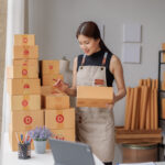 Starting Small business entrepreneur SME freelance, Portrait young woman working at home office, BOX, smartphone, laptop, online, marketing, packaging, delivery, b2b, SME, e-commerce concep