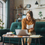Happy Accounting at Home: Cheerful Smiling Woman Using Laptop Computer, Filling Tax Forms. Businesswoman Solving All His Paperwork Problems, Finishes the Job: Bills, Invoices, Has Financial Success